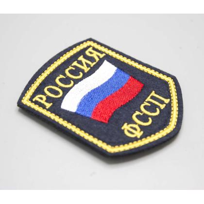 Где купить Шеврон вышитый РОССИЯ ФССП, темно-синие поле ( шелк ) с липучкой в Москве недорого с доставкой по России