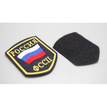 Где купить Шеврон вышитый РОССИЯ ФССП, темно-синие поле ( шелк ) с липучкой в Москве недорого с доставкой по России