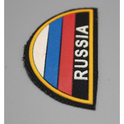 Где купить Шеврон пластизолевый Россия (полукруг МЧС триколор) на черном фоне  ( 9x5 ) недорого в Москве с доставкой по России
